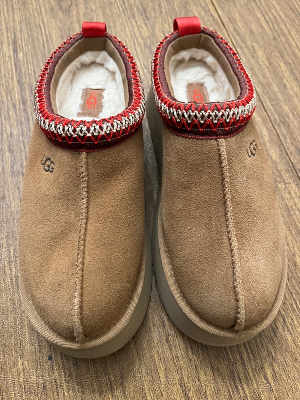 UGG Chestnut Suede Slip-On Clogs with Red Trim and Cream Lining.